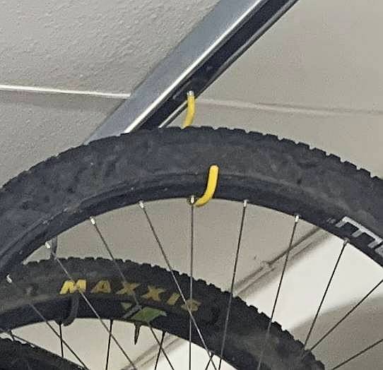 closeup photo of wheel hanging on unistrut hook